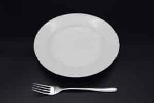 A pasta plate next to a fork - this shows the size of both items so you know what you are going to hire