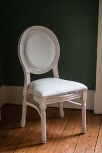 YES Hire's Louis chair against a dark green background