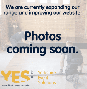 Two members of staff at YES Hire are installing a dancefloor behing text that says 'photos coming soon'