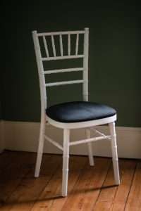 A White chiavari chair with a black velvet seat pad. These are available to hire in Yorkshire, the North East and beyond!