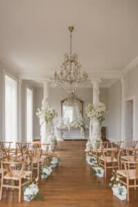The ceremony hall at Forcett Hall set up with wishbone chairs by YES Hire