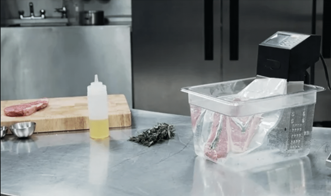 Buffalo Sous-vide Circulator 2 Apicture of a sous-vide circulator available to hire from YES Hire. It is set up in a kitchen, clipped to a gastronorm, available to hire separately.