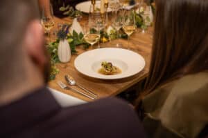 A fine dining white plate on a dressed table