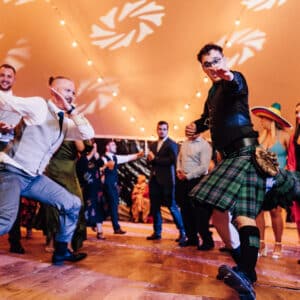 People dancing on a dance floor hired from YES Hire and installed in a marquee near Leeds