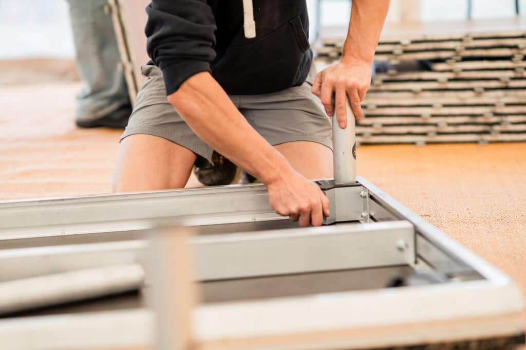 a YES Hire staff member installs a stage
