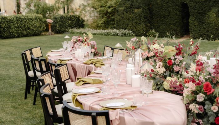 Serpentine Tables and french antieuq chairs set up at Sudeley Castle for a wedding photoshoot